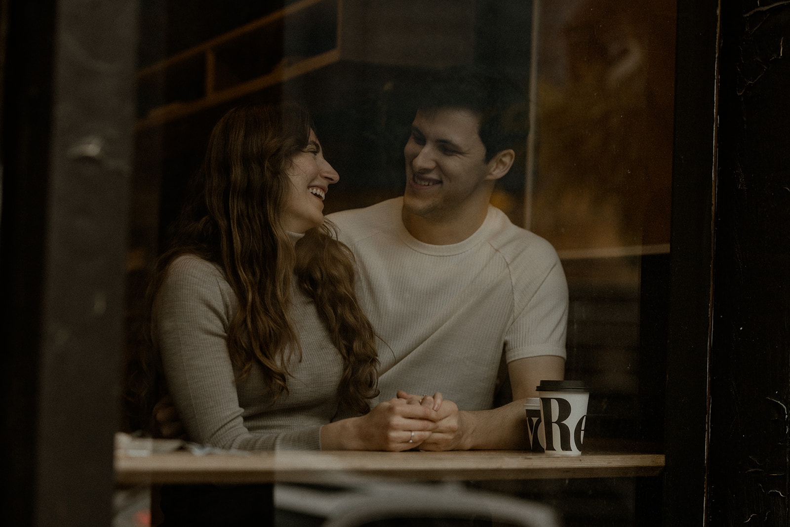 Winter engagement session in Gastown Vancouver featuring candid urban photos and a cozy coffee shop date at Revolver Coffee. Isle + Oak Photography are Vancouver engagement photographers specializing in natural, cinematic, story-driven imagery.